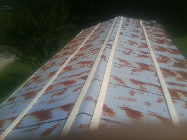 Rusted metal roof panels with new wood purlins before replacement — Storm Damage Roof Repair in Sullivans Island by Roofing Brothers