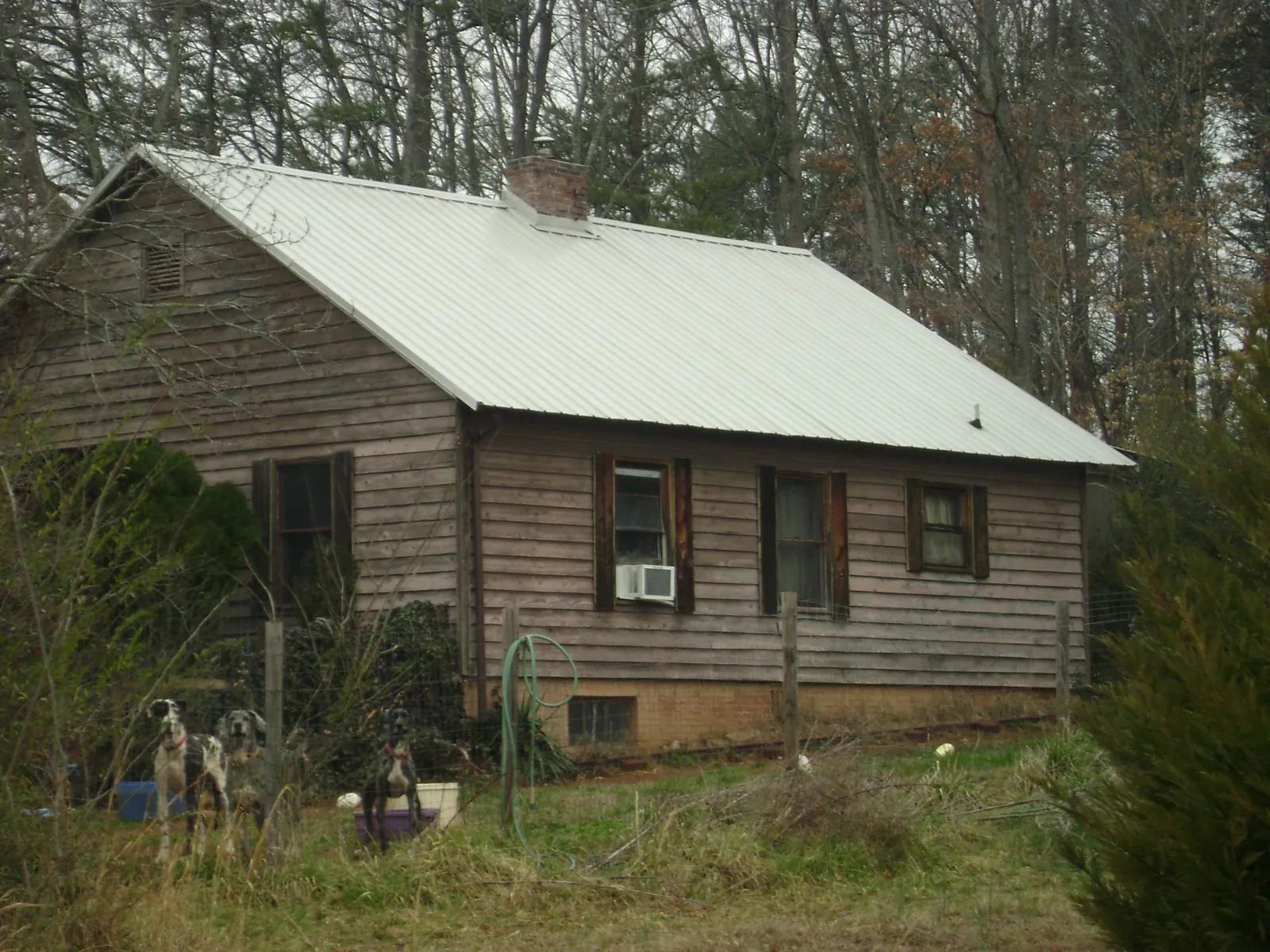 White metal roof on an old wood sided farmhouse, from a Metal Roof Installation job in Sullivans Island